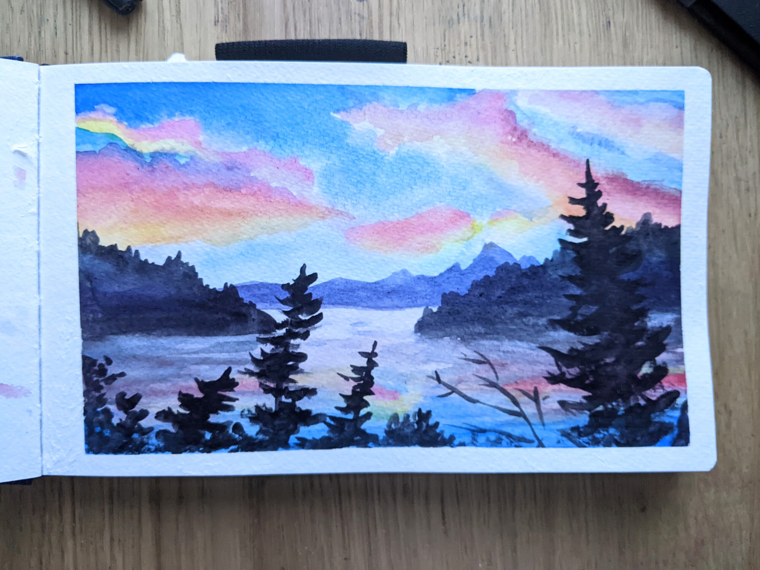 Painting of two islands jutting into a lake behind of a line of pines. Bright, bold sunset colors.