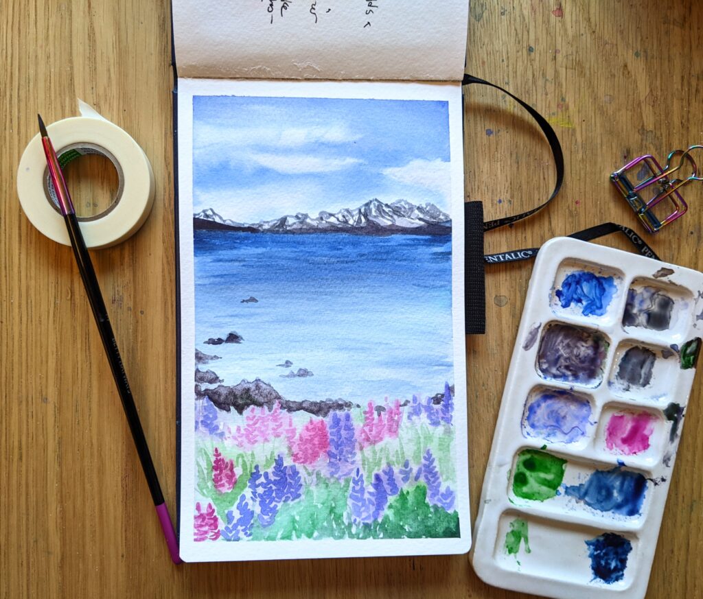Painting of flowers in front of a lake with mountains in the background